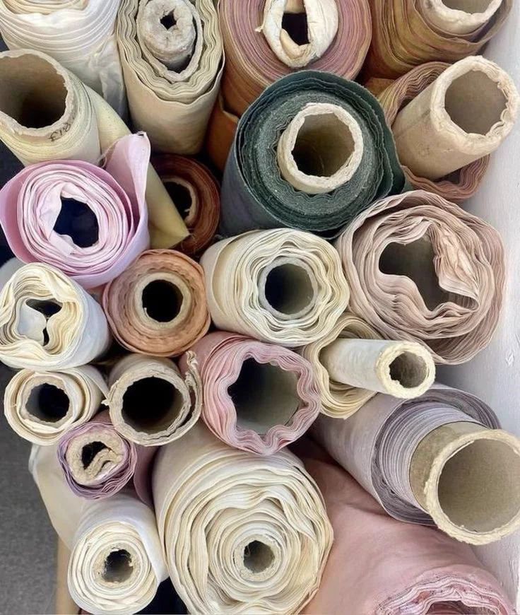 Rolls of fabric in soft neutral tones