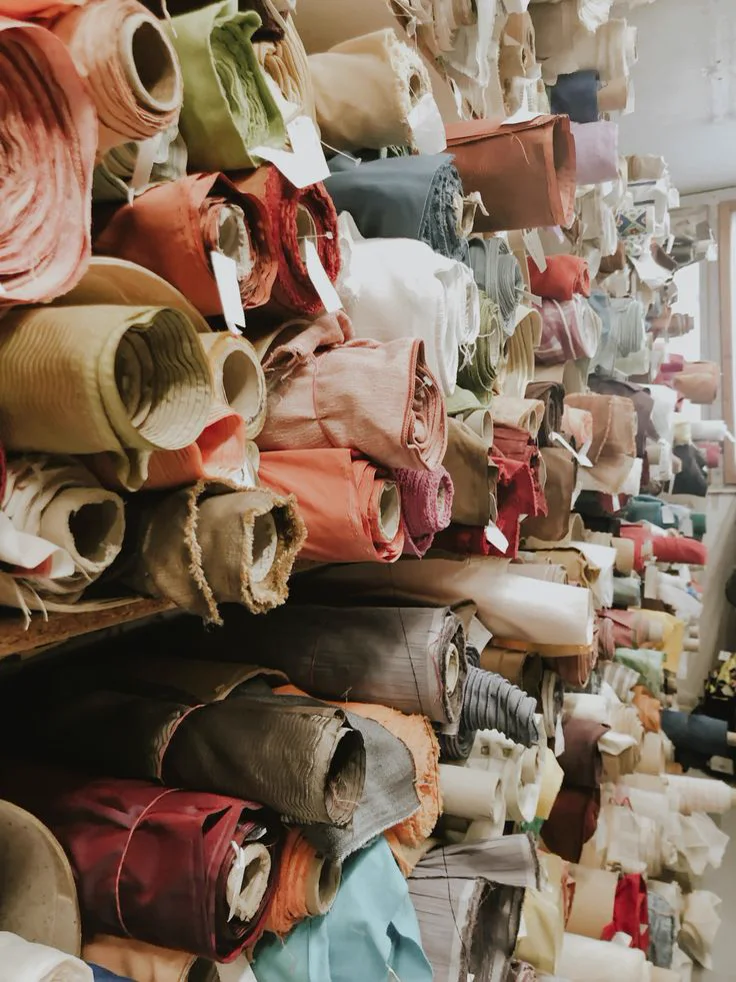Shelves of fabric rolls in a textile store